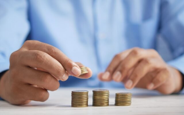 Stacking coins representing compound interest growth over time