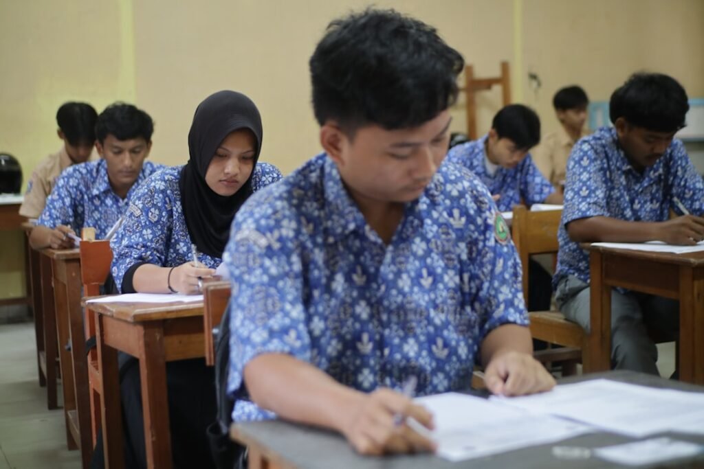 Students taking a test in a classroom representing GPA factors