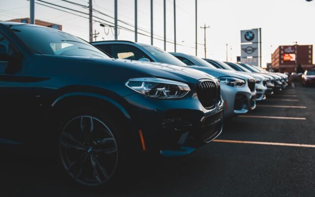Cars at a dealership representing factors that affect your auto loan interest rate