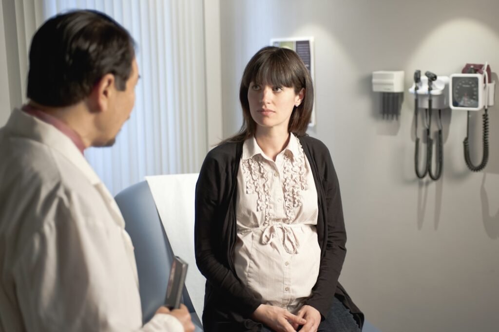 Obstetrician consulting a pregnant patient representing gestational age vs fetal age
