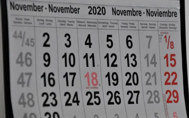 Wall calendar with marked dates representing calculating business days between dates