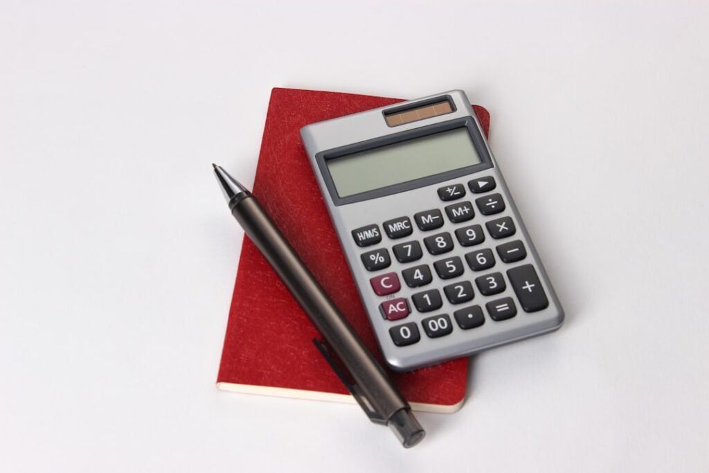 Calculator and notebook representing common mistakes calculating your needed final exam grade