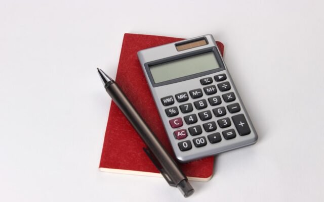 Calculator and notebook representing common mistakes calculating your needed final exam grade