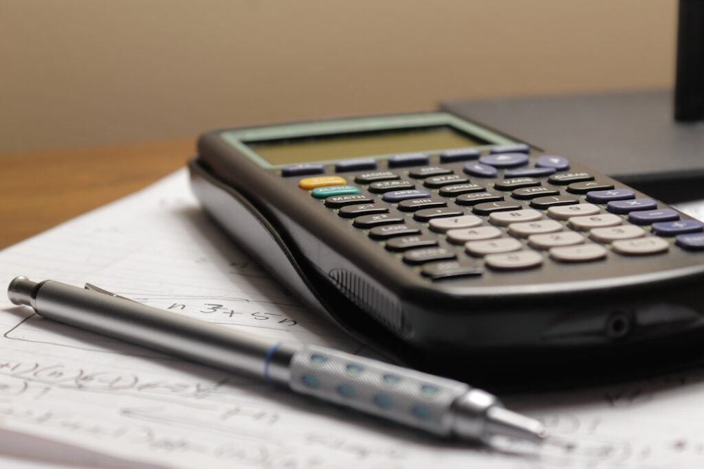 Calculator and pen on paper representing mental math percentage tricks