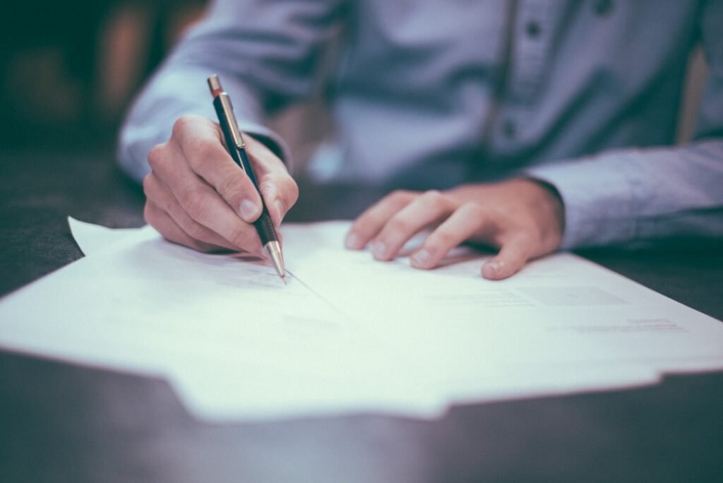 Person signing a document representing warning signs of a predatory loan