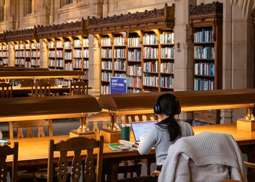 Student studying in a university library, representing GPA and academic planning