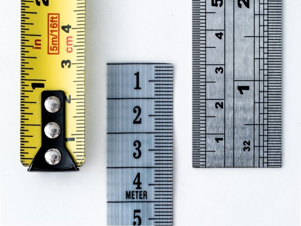Rulers and measuring tapes representing unit conversion mistakes and precision