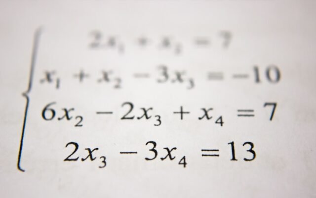 System of equations on paper representing common percentage calculation mistakes