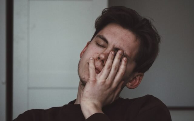 Person resting from fatigue representing signs of not eating enough calories